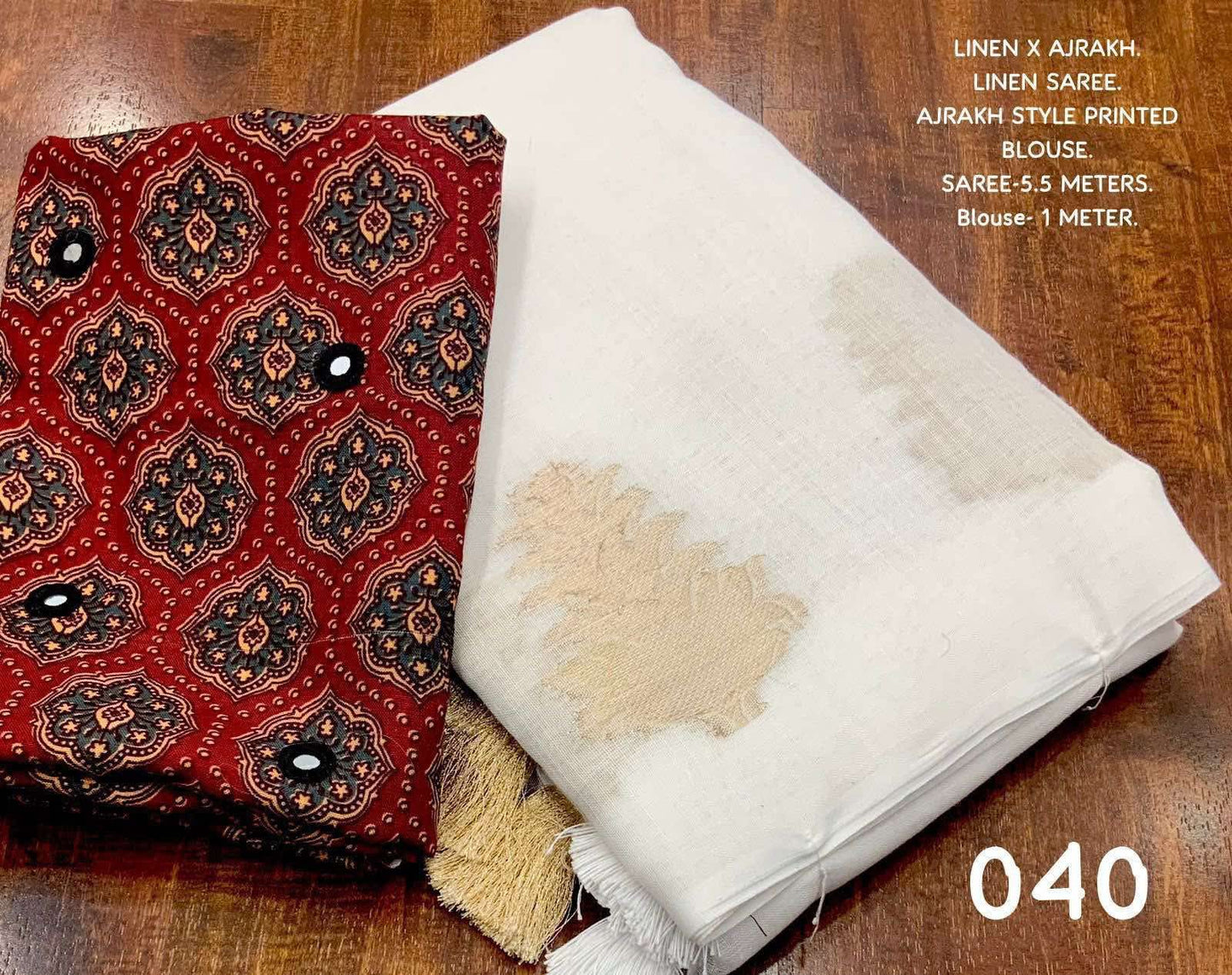 White LINEN Saree, featuring beautiful zari woven leaf design...pallu is adorned with cotton tassels...blouse is made of linen fabric with ajrakh style prints and foil mirror work