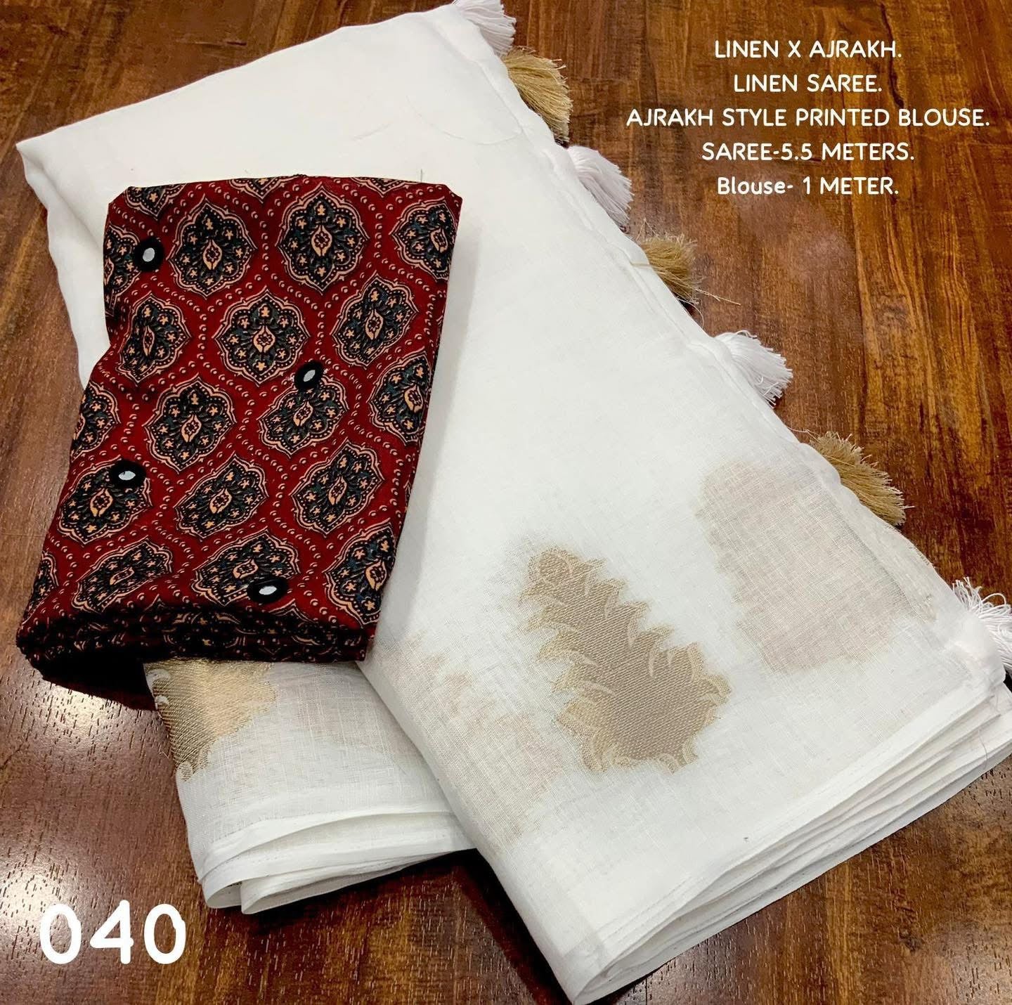 White LINEN Saree, featuring beautiful zari woven leaf design...pallu is adorned with cotton tassels...blouse is made of linen fabric with ajrakh style prints and foil mirror work