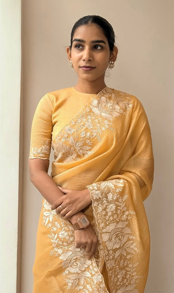 Gandham-hued crush organza saree, elevated with intricate ivory floral embroidery along the borders