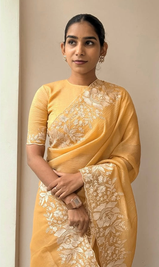 Gandham-hued crush organza saree, elevated with intricate ivory floral embroidery along the borders