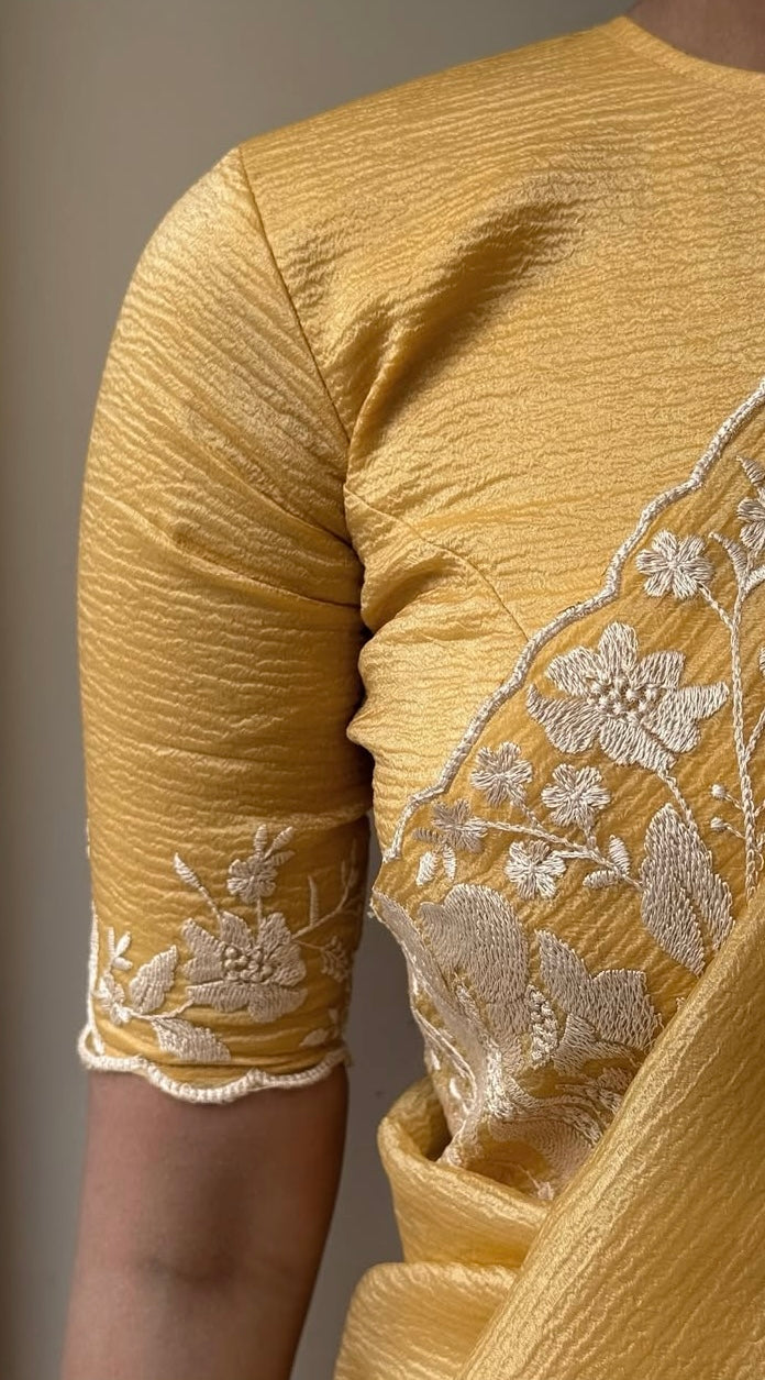 Gandham-hued crush organza saree, elevated with intricate ivory floral embroidery along the borders