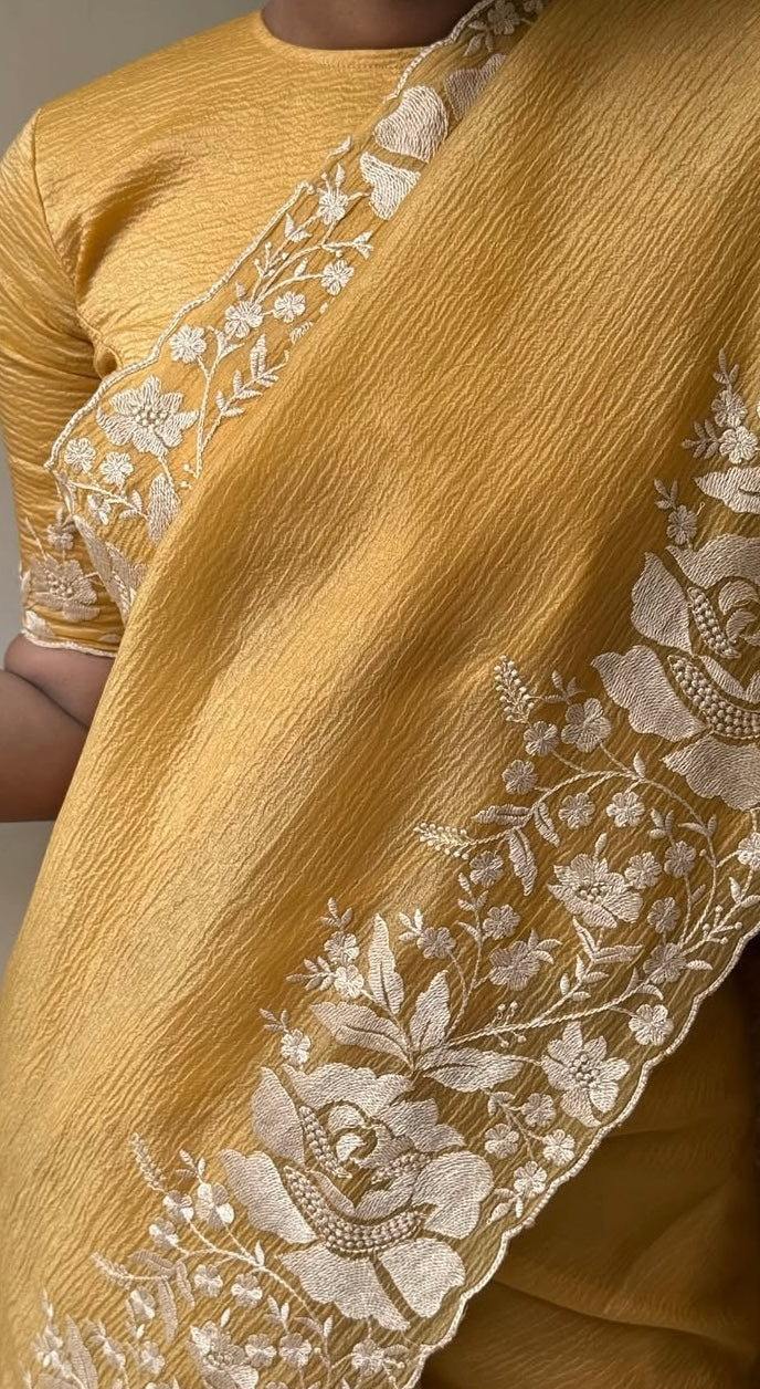 Gandham-hued crush organza saree, elevated with intricate ivory floral embroidery along the borders