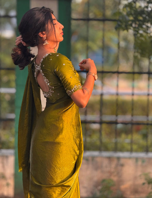 Olive Tone green space silk saree With its fluid shine and graceful drape paired with Hand-embroidered floral detailing Blouse piece with cut-out back for that extra glam