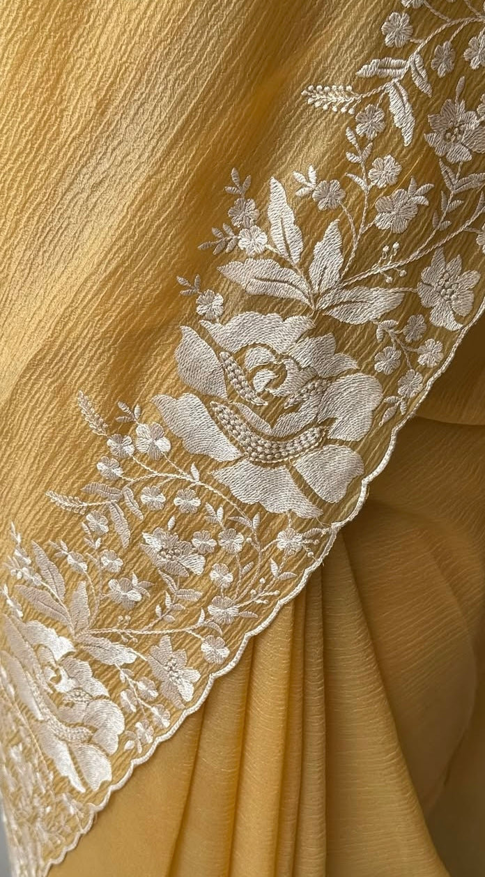 Gandham-hued crush organza saree, elevated with intricate ivory floral embroidery along the borders
